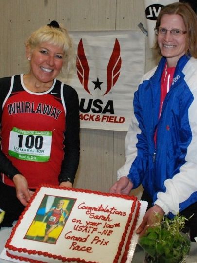 USATF-NE treated Sarah Prescott to a cake to celebrate completing her 100th consecutive NE GP championship. (Photo: Tom Derderian)