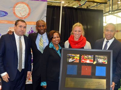 Meet director Mark Wetmore, Reggie Lewis Center director Keith McDermott, RCC President Dr. Valerie Robinson, and 2014 USA Indoor Pole Vault Champion Mary Saxer present a plaque of RLTAC highlights to Governor Deval Patrick. (Photo: Courtesy Roxbury Community College)