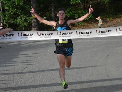 Louis Serafini breaks the tape at the Hollis Fast 5K (Jean Cann/USATF-NE)